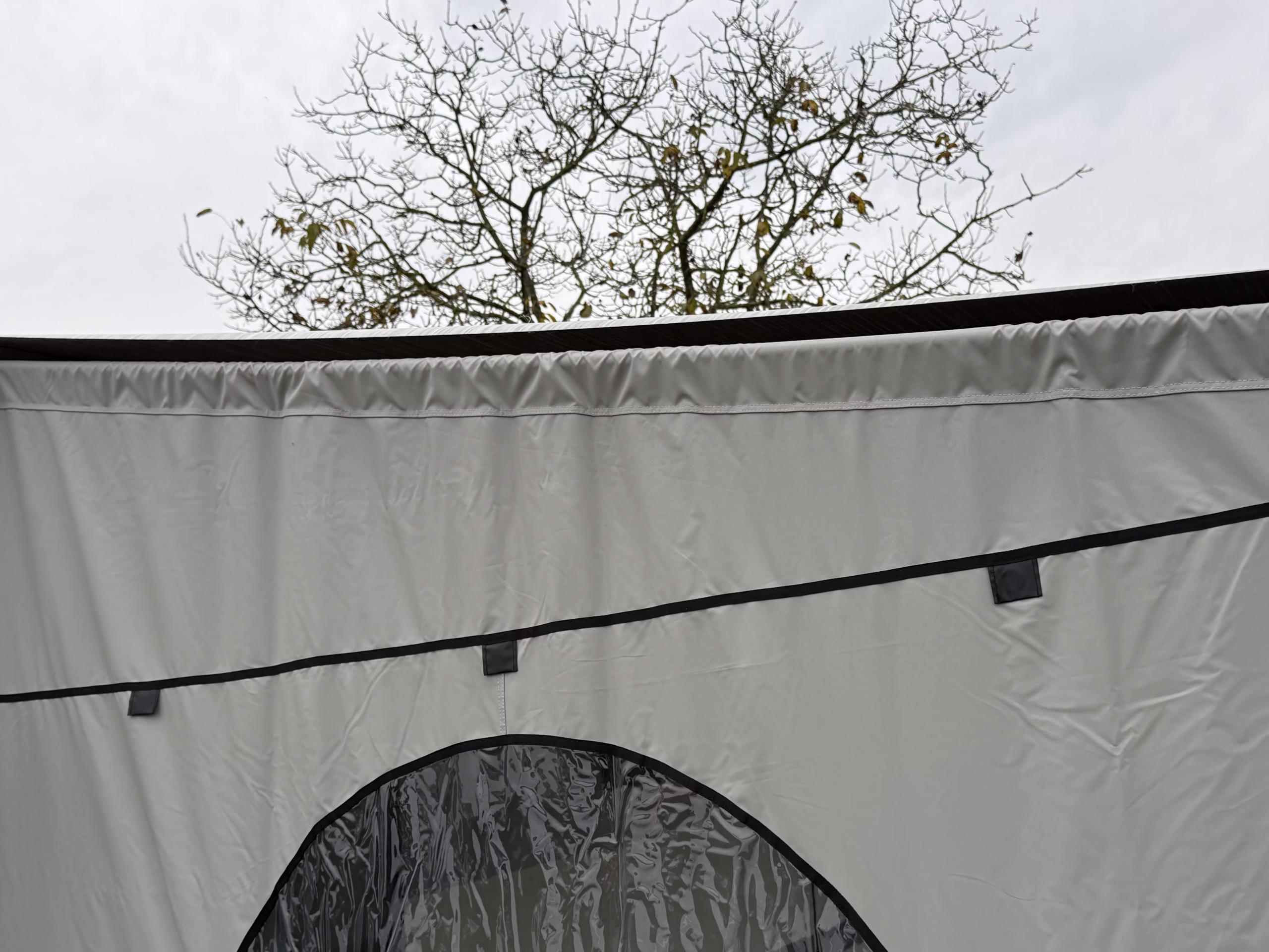 Zijpaneel met rond raam van de Travellife Scala luifeltent